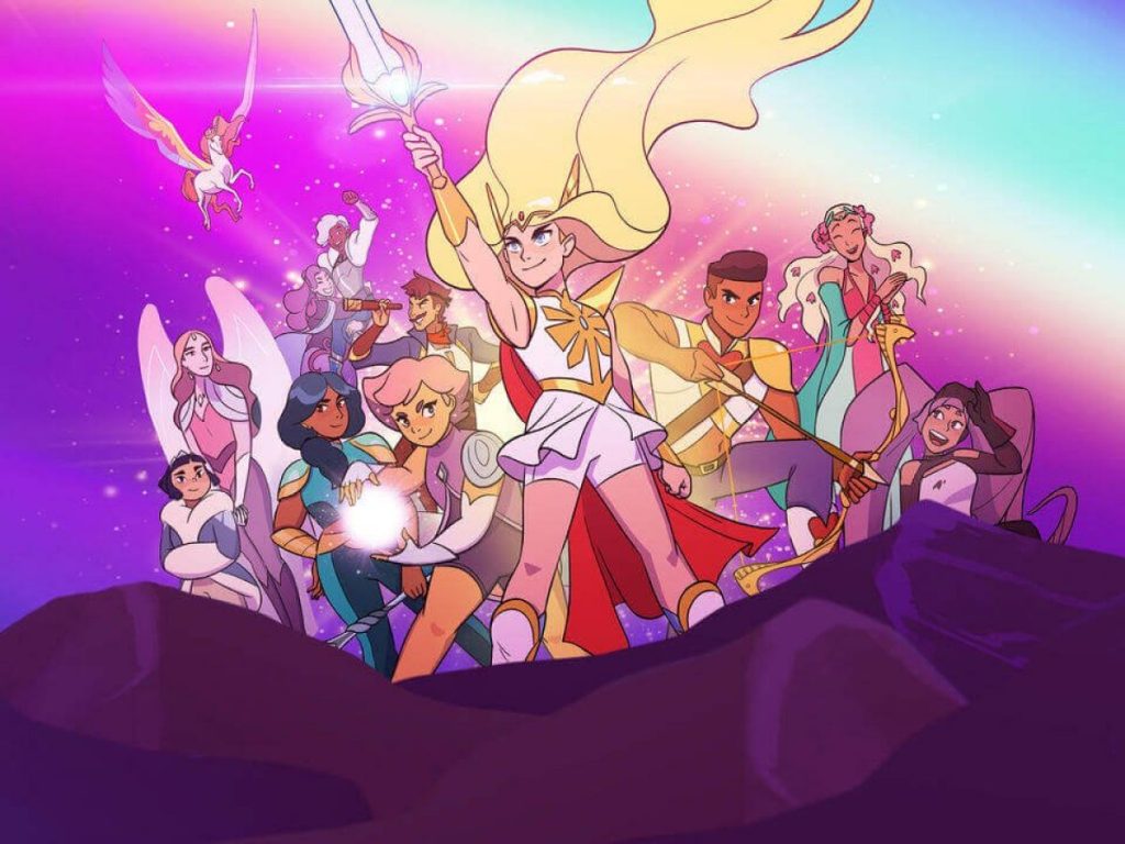 A collection of the characters within She-Ra surround Adora - the titular character - as she holds a glowing sword in the air.