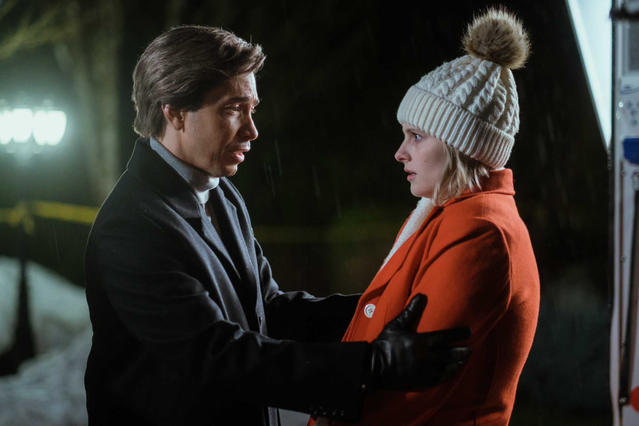 A still of Henry (Justin Long) and Winnie (Jane Widdop) in the film 'It's a Wonderful Knife'. Henry stands in front of Jane, holding her by the shoulders. Jane has an alarmed expression on her face.